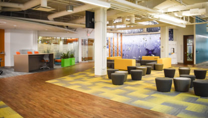 SAP's open concept work area, with colourful carpets, and a variety of seating areas.
