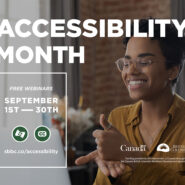 A person of colour is smiling and signing into a computer. Text: Accessibility Month.