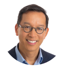 David Wong of ICBC's headshot. He is a man of colour with dark hair and glasses. He is wearing a black suit with a blue collared shirt.